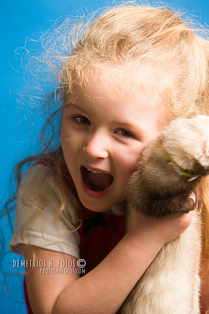 Girl smiles with her pet ferret