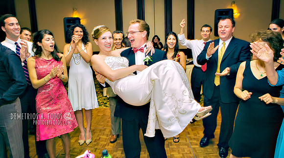 Groom carries his Bride