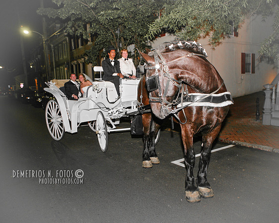 The bride and groom take of on a horse driven carrage